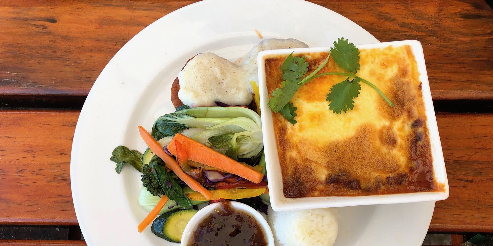 Bobotie with a golden egg topping served with yellow rice