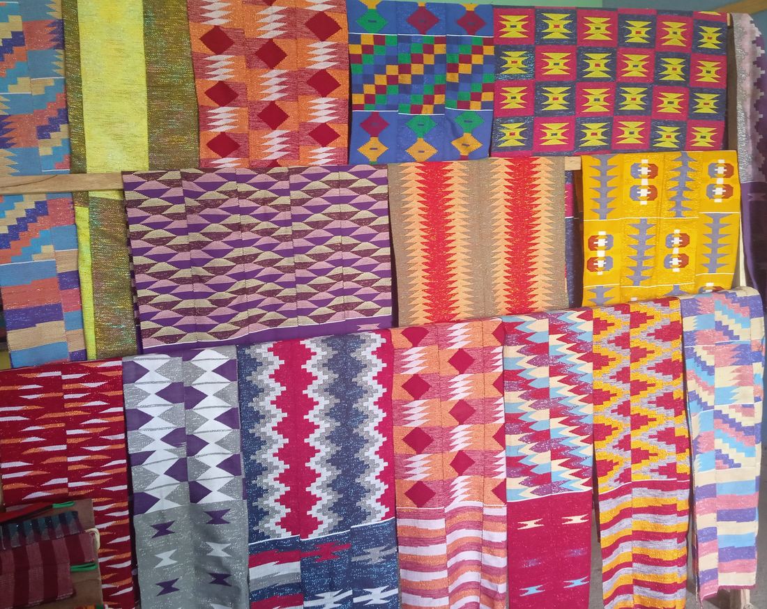 Several Ewe kente cloths with different patterns laid out in Tafi, Volta Region